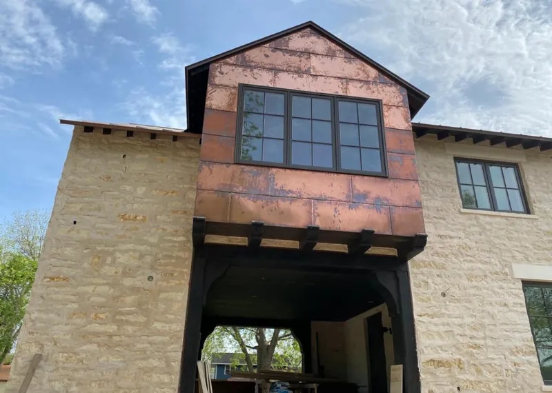 Copper metal panel facade on a stone building for Skylight Installation in Loveland